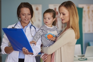 mom and girl with female doctor small